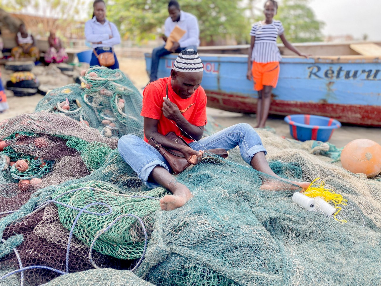 Fisherman repairing nets Sierra Leone