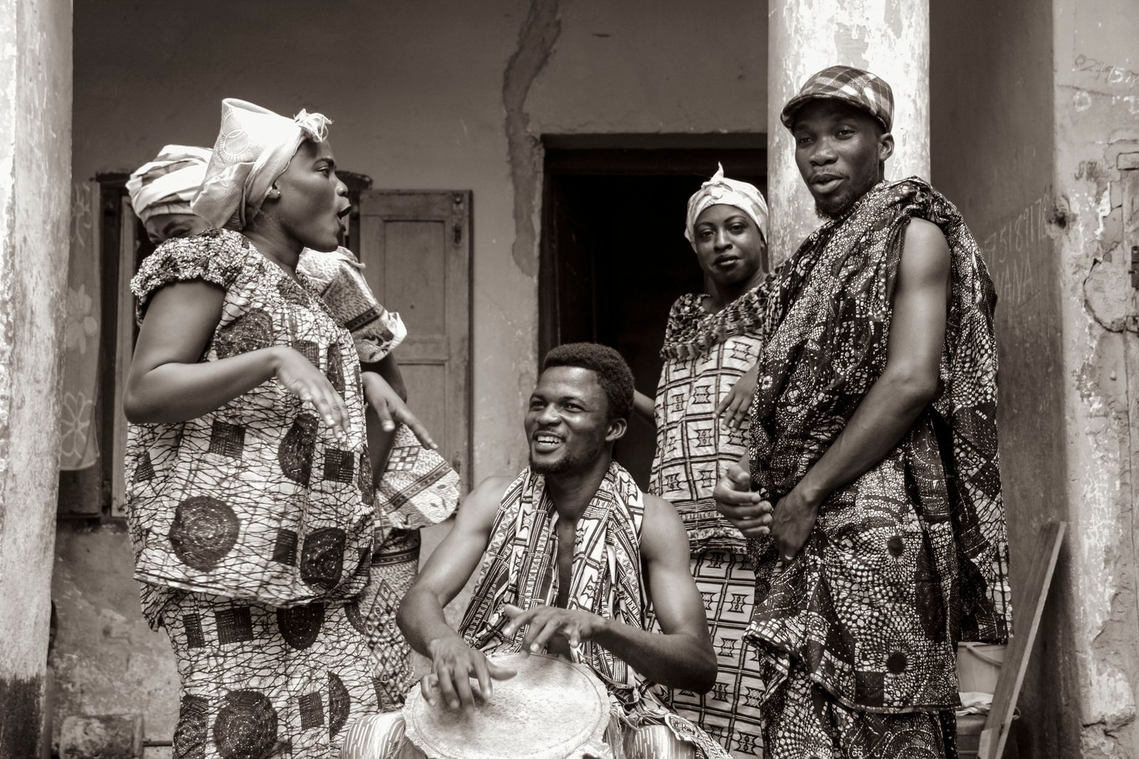 Adults in traditional Ghanaian attire at a cultural gathering